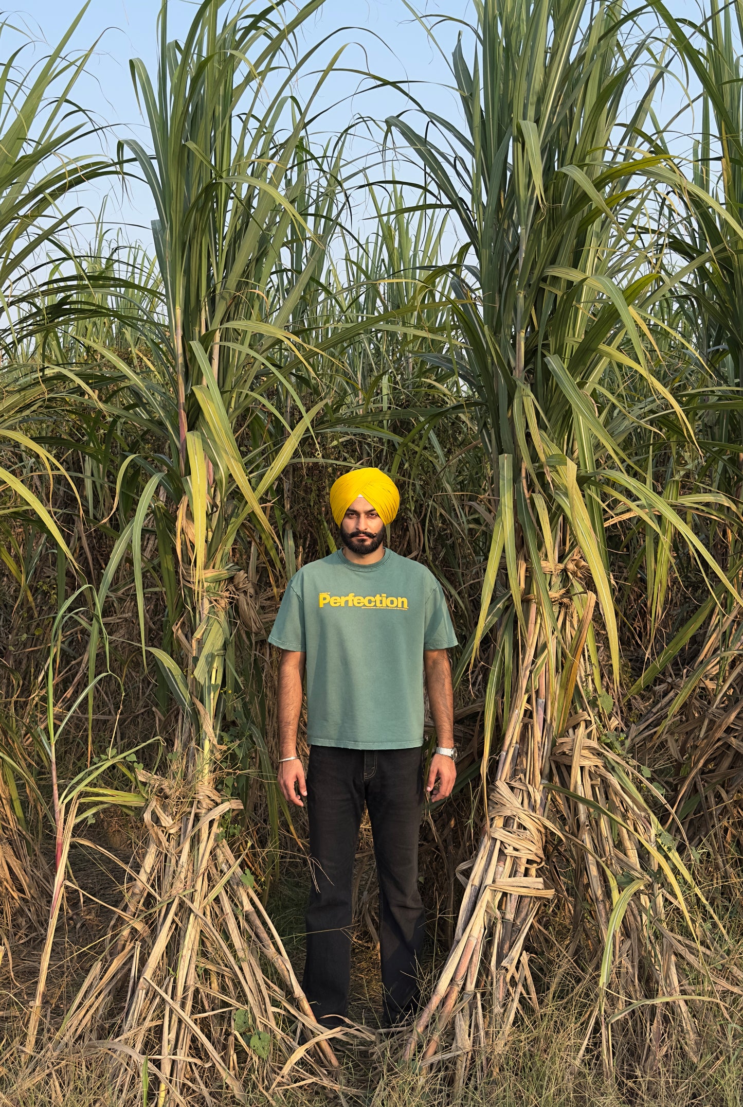 Acid-Washed Malachite Green T-Shirt with yellow print.