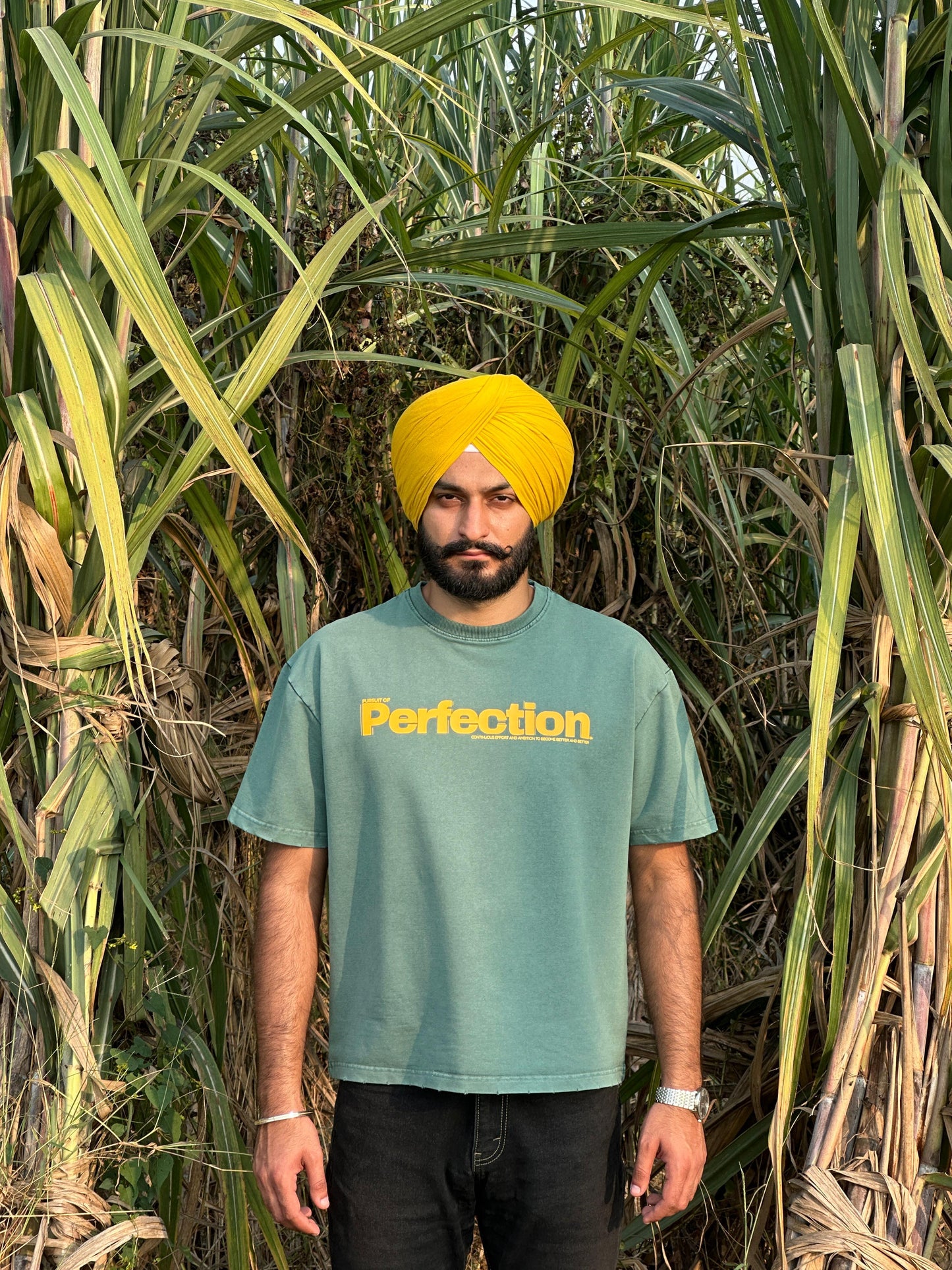 Acid-Washed Malachite Green T-Shirt with yellow print.